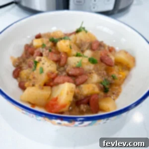 Hearty Slow Cooker Cowboy Casserole with melted cheese and fresh herbs
