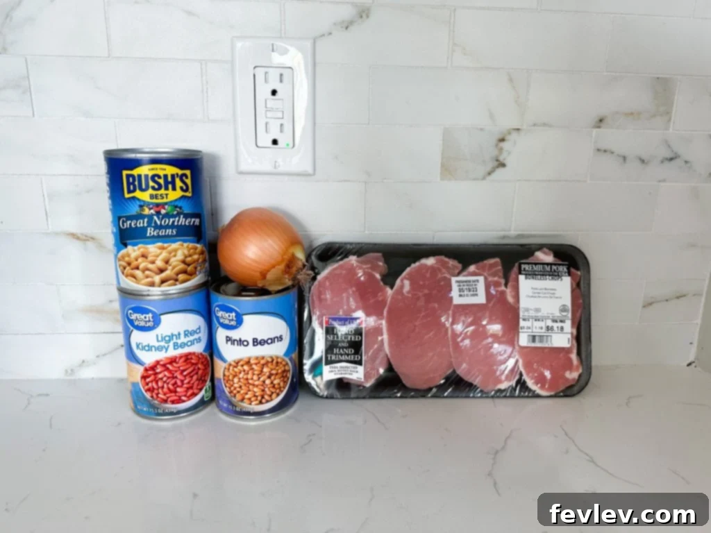 Perfectly seared pork chops served alongside a generous portion of Instant Pot baked beans, garnished with fresh herbs.