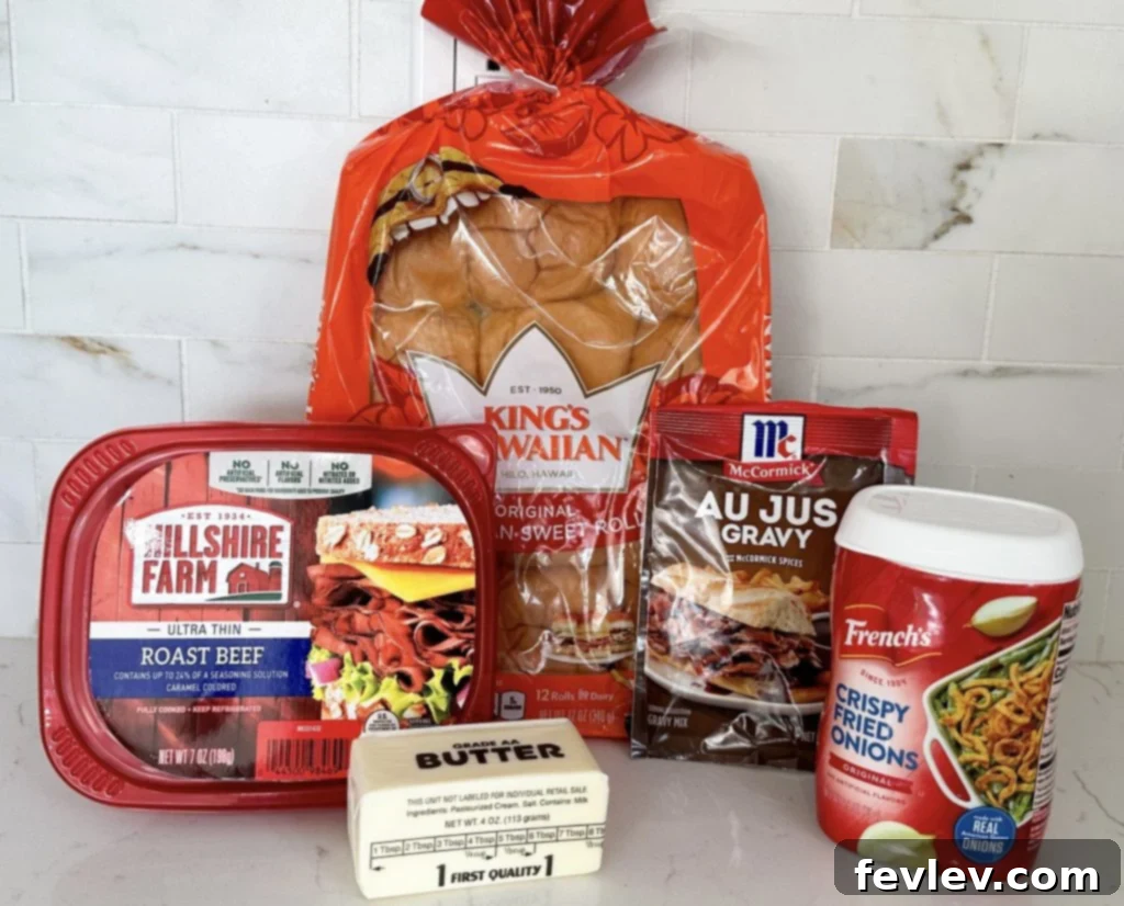 Close-up of ingredients for French Dip Sliders: Hawaiian rolls, roast beef, provolone, and au jus mix