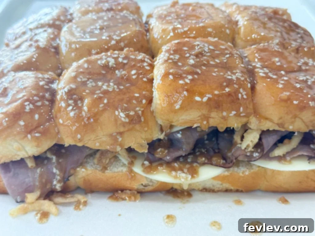 French Dip Sliders baking in the oven, cheese melting
