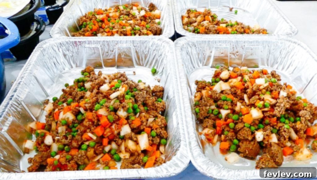 Seasonings being added to browned ground beef in a skillet.