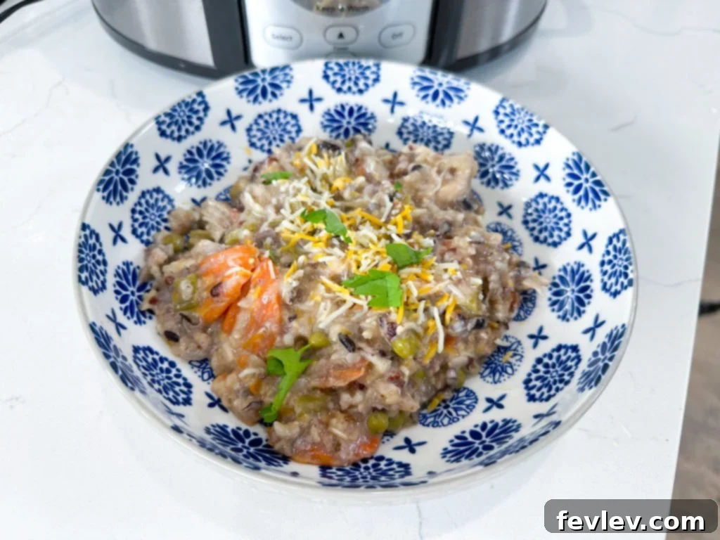 Cooked BBQ chicken shredded in a slow cooker, ready to be served.