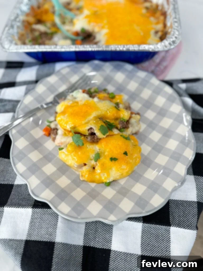 Fiesta Chicken Casserole with cheese on top, ready for baking.