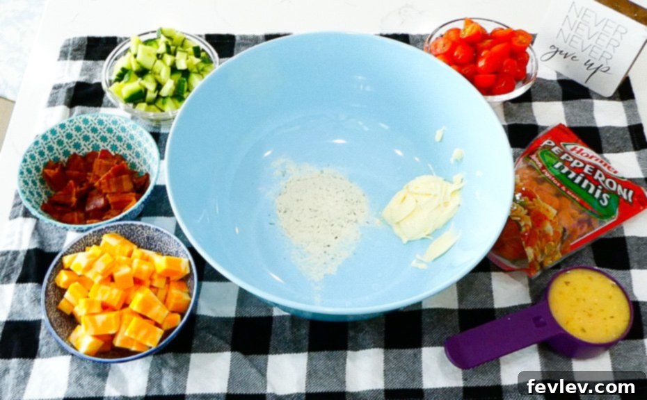 Ranch Kissed Italian Pasta Salad 5 Freshly diced English cucumber and halved cherry tomatoes, providing vibrant color and refreshing crunch for the pasta salad.
