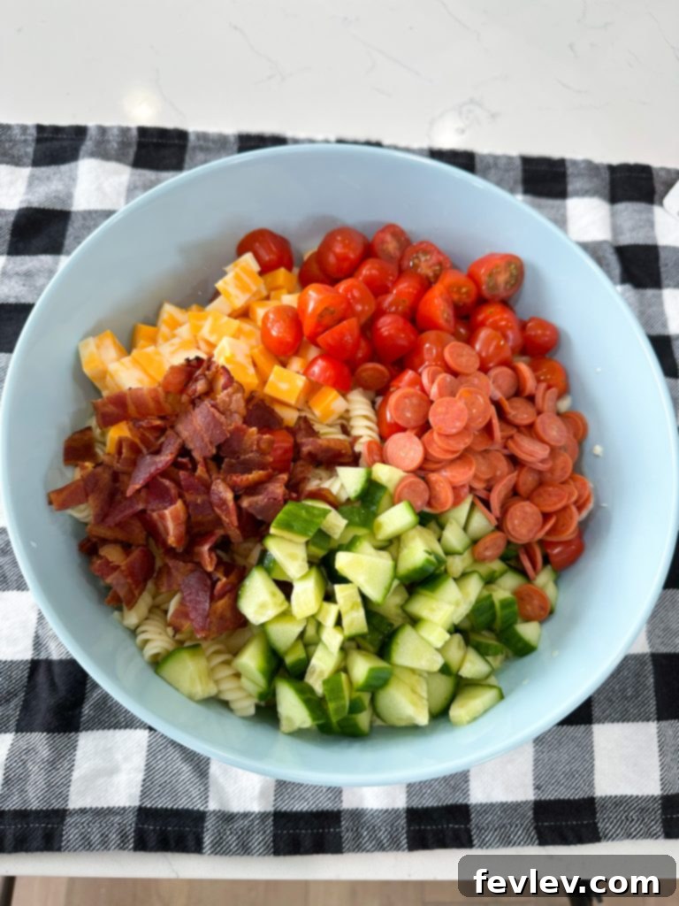 Ranch Kissed Italian Pasta Salad 7 Ingredients for the creamy Italian Ranch dressing, including mayonnaise, ranch seasoning, and Italian dressing, waiting to be whisked.