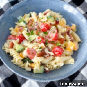 A close-up shot of the finished Italian Ranch Pasta Salad, beautifully garnished and ready to serve, highlighting its vibrant colors and appealing textures.