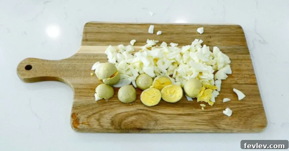 Hard-boiled eggs being peeled.