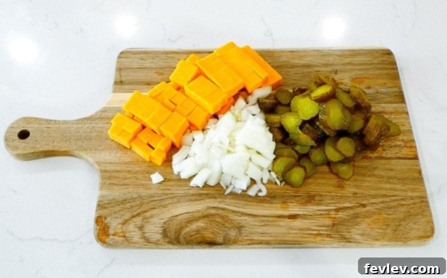 Cheddar cheese being cubed
