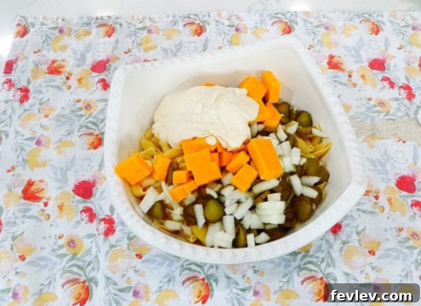 Adding dressing to pasta salad