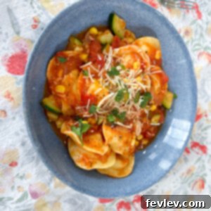 Delicious Summer Vegetable Ravioli served in a large bowl, garnished with fresh herbs.
