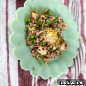 One-Pot Chicken and Wild Rice Dinner 2 Delicious one-pot chicken with wild rice garnished with fresh herbs in a Dutch oven.