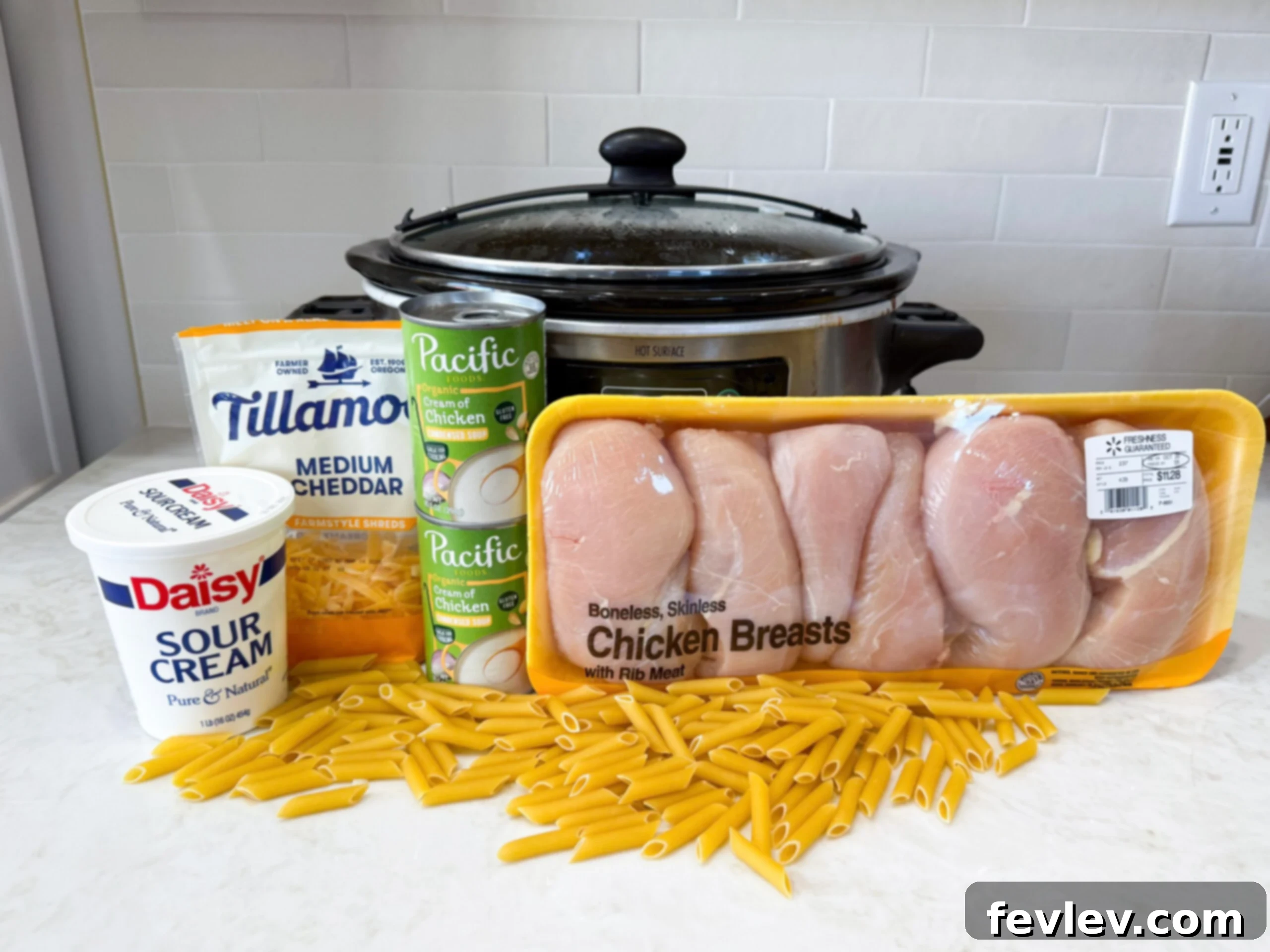 Velvety Slow Cooker Rotel Chicken Pasta 4 Ingredients for creamy Rotel chicken pasta laid out on a kitchen counter.