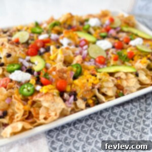 Delicious Loaded Nachos Sheet Pan Dinner with melted cheese and fresh toppings, ready to serve.
