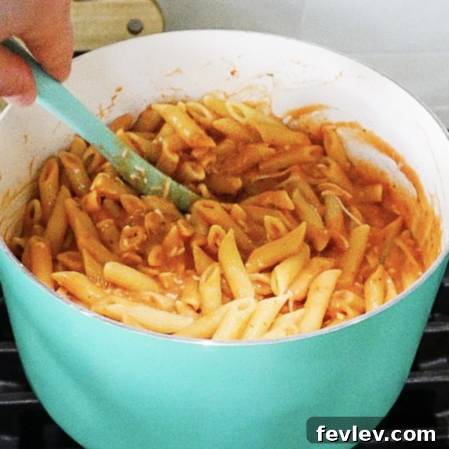 Effortless One Pot Creamy Pasta 6 The finished one-pot creamy pasta dish, freshly stirred, showcasing the rich sauce and perfectly coated penne.