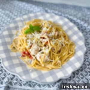 Delicious One Pot Chicken Spaghetti served in a bowl, garnished with fresh basil