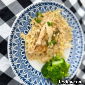 Perfectly seared chicken breast smothered in a rich, creamy garlic parmesan sauce, garnished with fresh parsley.