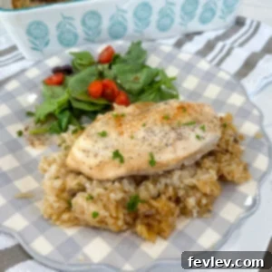 Delicious Dump and Go No-Peek Chicken and Rice Casserole fresh from the oven, garnished with parsley.