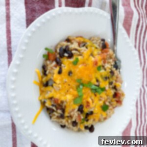 A vibrant bowl of Black Beans and Rice, garnished and ready to eat.