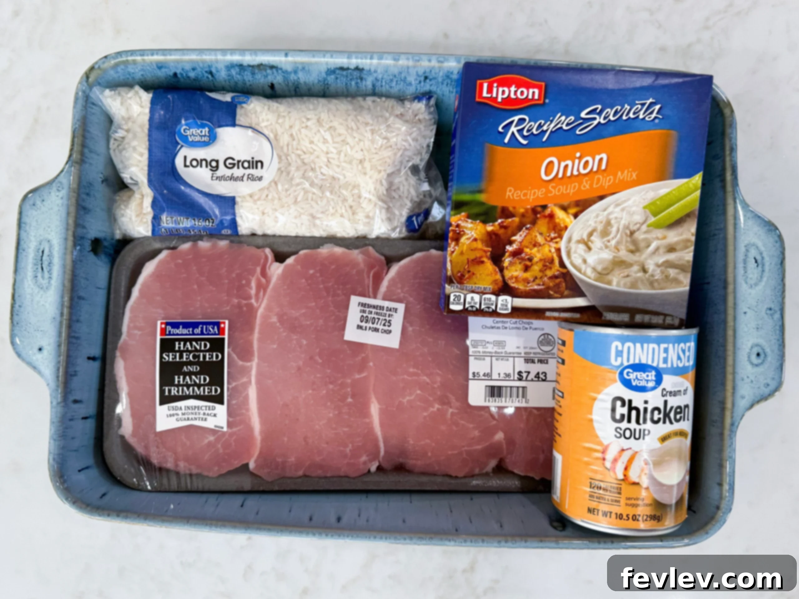 One-Pan Pork Chop Perfection 4 Ingredients for No Peek Pork Chop Casserole including raw boneless pork chops, jasmine rice, cans of cream of chicken and cream of mushroom soup, a box of chicken broth, and a packet of onion soup mix.