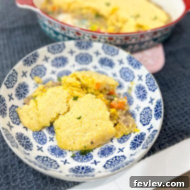 Homestyle Turkey Pot Pie 2 A golden-brown turkey pot pie with a cornbread crust, fresh out of the oven, ready to be served.