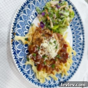 Perfectly seared Tuscan Pork Chops in a rich, creamy garlic sauce with sun-dried tomatoes and fresh spinach