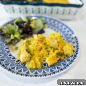 Delicious Chicken and Yellow Rice Casserole, topped with melted cheese, ready to serve.
