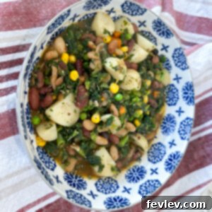 A vibrant and hearty Mixed Bean Hash in a rustic skillet, garnished with fresh herbs, ready to be served