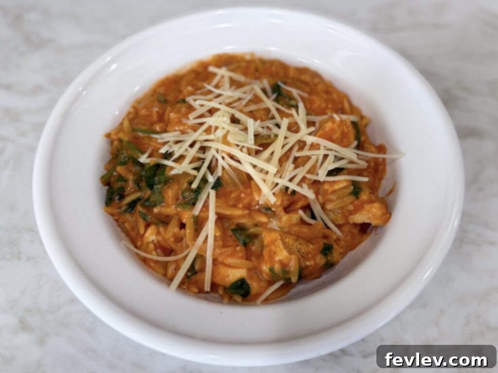 Easy one-pan chicken and spinach with orzo pasta dinner.
