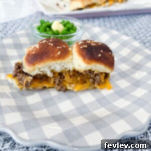 Delicious Hamburger Sliders piled high with cheese and ground beef on dinner rolls