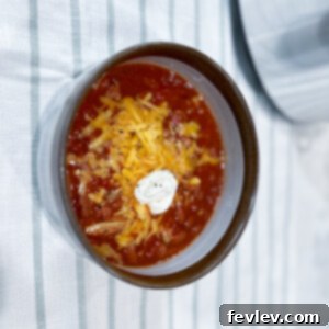 Hearty Ground Turkey Chili garnished with fresh herbs, ready to be served