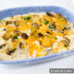 A delicious and hearty Sausage and Potato Casserole, baked to golden perfection with melted cheese on top, perfect for a family meal or special brunch.
