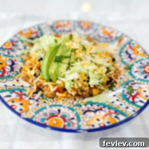 A vibrant bowl of one-pot Mexican Rice and Chicken, garnished with fresh cilantro and avocado