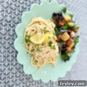 Delicious Lemon Chicken Spaghetti garnished with fresh herbs, ready to serve.