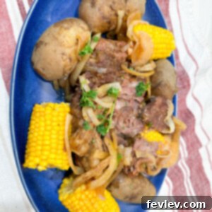 A hearty slow cooker pot roast surrounded by tender potatoes and sweet corn, ready to be served.