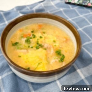 Cozy Chicken and Dumplings in a bowl, garnished with fresh herbs
