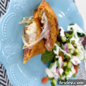 Delicious golden brown ham and cheese calzone with Italian seasoning