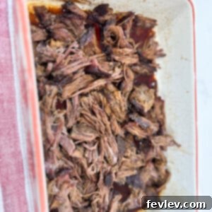 A perfectly baked chuck roast, tender and juicy, surrounded by rich seasonings and vegetables.