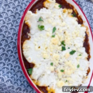Delicious Chili Mashed Potato Bake, a comforting casserole with golden-brown mashed potato topping and melted cheese, ready to be served
