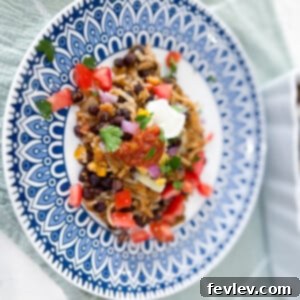 Delicious Black Bean Hash Brown Casserole with a crispy top, garnished with fresh herbs, ready to serve for a hearty meal.