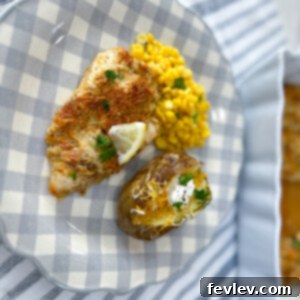 Crispy Baked Garlic Parmesan Chicken on a baking dish, garnished with fresh parsley