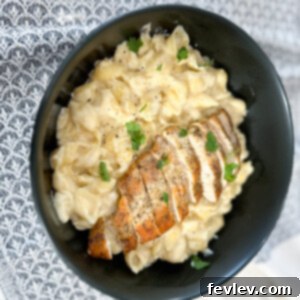 Creamy Garlic Parmesan Chicken Pasta dish, garnished with fresh herbs, ready to serve.