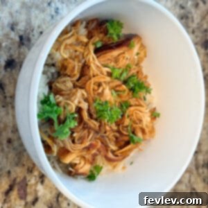 Delicious Barbecue Orange Chicken served over fluffy white rice with fresh green onion garnish
