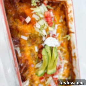 Delicious Enchilada Meatball Casserole baked in a dish, topped with melted cheese and fresh garnishes like cilantro and avocado.