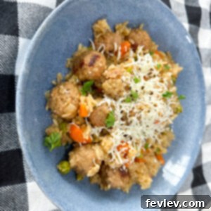 Delicious one-pot rice and meatball dinner served in a skillet, garnished with fresh herbs, ready to be enjoyed by a family.