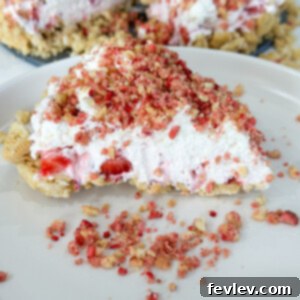 Delicious Strawberry Crunch Cheesecake with a creamy filling and a vibrant strawberry crumble topping.