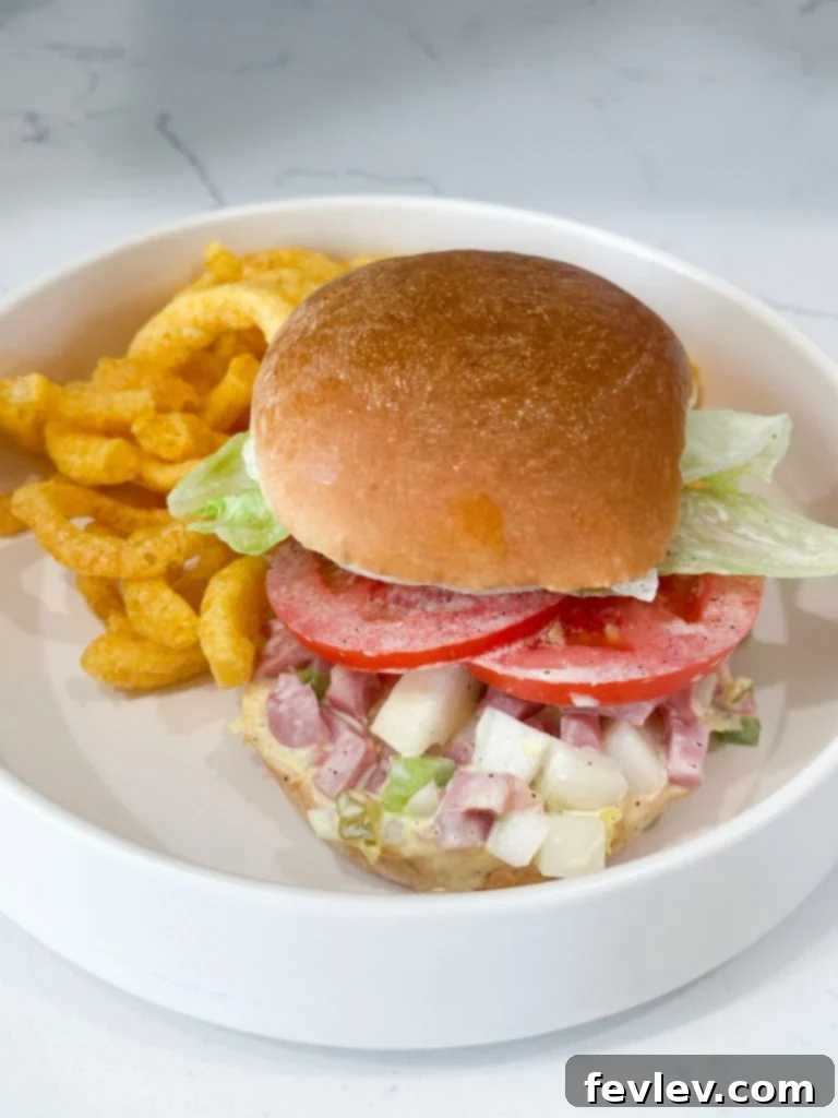 Creamy Ham Salad Sandwiches 5 Ham salad in a bowl with a spoon, ready for serving