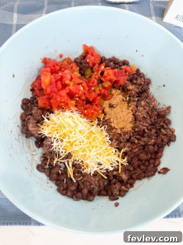 Black Bean Fiesta Burritos 3 Hands preparing black bean burritos, showing the filling process