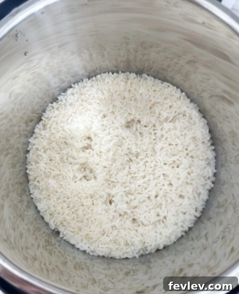 Budget-Friendly Chicken Broccoli Rice 3 A pot of cooked white rice, ready to be added to the casserole