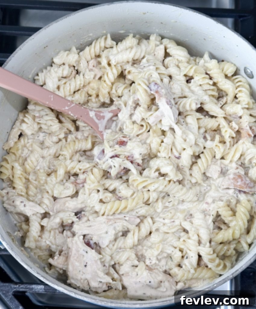 Ultimate Rotisserie Chicken Bacon Alfredo 6 rotisserie chicken bacon alfredo simmering sauce