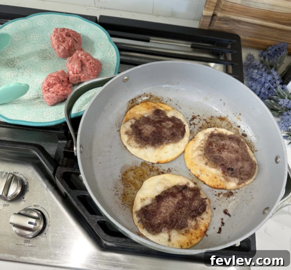 Hamburger tacos cooking in a skillet